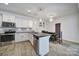 Bright kitchen with white cabinets, stainless steel appliances, an island, and an adjacent dining area at 5125 Thomasville Dr, Belmont, NC 28012