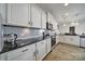 Bright kitchen features white cabinets, stainless steel appliances, and dark countertops at 5125 Thomasville Dr, Belmont, NC 28012