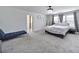 Bright main bedroom featuring carpeted floors, a decorative ceiling fan and a sitting area at 5125 Thomasville Dr, Belmont, NC 28012