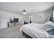 Bright main bedroom featuring carpeted floors, a decorative ceiling fan, and a television at 5125 Thomasville Dr, Belmont, NC 28012