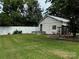 Backyard featuring a lush lawn, privacy fence, and outbuilding at 522 W Congress St, Lincolnton, NC 28092