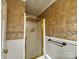 Bathroom featuring a shower with a gold-framed glass door and tiled walls with decorative accents at 522 W Congress St, Lincolnton, NC 28092