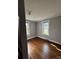 Bright bedroom with hardwood floors, two windows offering natural light, and neutral paint at 522 W Congress St, Lincolnton, NC 28092