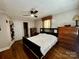 Inviting bedroom with hardwood floors, neutral tones, and a comfortable bed with a dark headboard at 522 W Congress St, Lincolnton, NC 28092