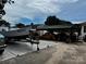 Exterior view of covered carport with boat on trailer, yellow car, and other vehicles at 522 W Congress St, Lincolnton, NC 28092