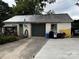 View of the detached garage with a concrete driveway and some personal items at 522 W Congress St, Lincolnton, NC 28092