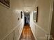 Hallway with hardwood floors, decorative wall panels, and framed art at 522 W Congress St, Lincolnton, NC 28092