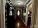 Inviting hallway with dark floral wallpaper, hardwood floors, and charming architectural details at 522 W Congress St, Lincolnton, NC 28092