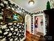 Hallway with floral wallpaper leading to other rooms, complemented by hardwood floors at 522 W Congress St, Lincolnton, NC 28092
