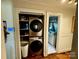 Laundry closet with stacked washer and dryer and shelving for storage at 522 W Congress St, Lincolnton, NC 28092