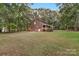 Expansive backyard with mature trees, a covered porch, patio and lush green lawn at 5317 Black Oak Ln # 11, Waxhaw, NC 28173
