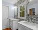 Bright bathroom featuring dual vanities, modern fixtures, and stylish mosaic backsplash at 5317 Black Oak Ln # 11, Waxhaw, NC 28173
