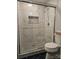 Bathroom featuring a walk-in shower with glass doors and decorative tile at 5317 Black Oak Ln # 11, Waxhaw, NC 28173