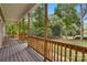 Spacious covered front porch with wood railings and a view of the lush surrounding greenery at 5317 Black Oak Ln # 11, Waxhaw, NC 28173