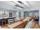 Open kitchen and dining area with stainless steel appliances, white cabinets, and modern lighting at 5317 Black Oak Ln # 11, Waxhaw, NC 28173