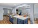 Kitchen island features a stainless steel sink, navy cabinets, and an open layout to the dining and living areas at 5317 Black Oak Ln # 11, Waxhaw, NC 28173