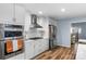 Updated kitchen with stainless steel appliances, modern range hood, and light wood floors at 5317 Black Oak Ln # 11, Waxhaw, NC 28173