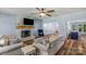 Comfortable living room with a stone fireplace, ceiling fan, and open access to the dining area at 5317 Black Oak Ln # 11, Waxhaw, NC 28173