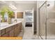 Well-lit bathroom featuring double sinks, wood cabinets, and a glass-door shower at 5655 Arnold Way, Mount Pleasant, NC 28025