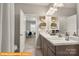 Bathroom featuring double sinks, wooden cabinets, and decorated woven baskets at 5655 Arnold Way, Mount Pleasant, NC 28025