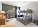 A bedroom features a gray bunk bed and a dinosaur skeleton mural on the wall at 5655 Arnold Way, Mount Pleasant, NC 28025