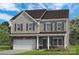 Charming two-story home featuring a two-car garage and classic architectural details at 5655 Arnold Way, Mount Pleasant, NC 28025