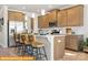 Spacious kitchen with island seating, stainless appliances, and stylish pendant lighting at 5655 Arnold Way, Mount Pleasant, NC 28025