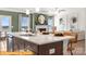 Open concept living room with kitchen view, large island and sink, stone countertops and stainless appliances at 5655 Arnold Way, Mount Pleasant, NC 28025