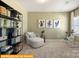Bright sitting room with comfortable seating, exercise bike, and stylish shelving at 5655 Arnold Way, Mount Pleasant, NC 28025