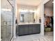 Bright bathroom showcasing a double vanity, storage, and glass shower leading into walk-in closet at 5811 Mantle Way, Kannapolis, NC 28081