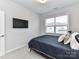 Cozy bedroom featuring a TV mounted on the wall and natural light through a window at 5811 Mantle Way, Kannapolis, NC 28081