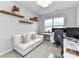 Comfortable home office space including a white sofa, desk, and a shelving unit provides great storage at 5811 Mantle Way, Kannapolis, NC 28081