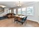 The dining room features hardwood floors, large windows for natural light, and modern furnishings at 5811 Mantle Way, Kannapolis, NC 28081