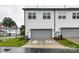 Two-story townhouse showcasing a gray garage door, white siding, and manicured lawn at 5811 Mantle Way, Kannapolis, NC 28081