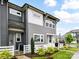 Gray two-story townhouse featuring a white picket fence and meticulously maintained landscaping at 5811 Mantle Way, Kannapolis, NC 28081