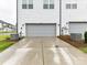 Spacious two-car garage with a concrete driveway and well-maintained landscaping at 5811 Mantle Way, Kannapolis, NC 28081