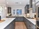 Functional kitchen showcasing gray cabinetry, hardwood floors, and stainless steel appliances at 5811 Mantle Way, Kannapolis, NC 28081