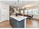 Bright kitchen area with an island and a view of the dining area and staircase at 5811 Mantle Way, Kannapolis, NC 28081