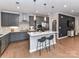 Modern kitchen with sleek gray cabinets, stainless steel appliances, and center island at 5811 Mantle Way, Kannapolis, NC 28081