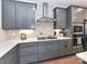 Stylish kitchen showcasing gray cabinets, modern appliances, and under-cabinet lighting at 5811 Mantle Way, Kannapolis, NC 28081