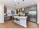Well-lit kitchen with stainless steel appliances, gray cabinets and a large center island at 5811 Mantle Way, Kannapolis, NC 28081