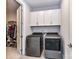 Functional laundry room equipped with gray washer/dryer, white cabinets, and easy access to the closet at 5811 Mantle Way, Kannapolis, NC 28081