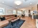 Open-concept living room boasts hardwood floors, a modern ceiling fan, and a comfortable sectional sofa at 5811 Mantle Way, Kannapolis, NC 28081