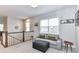 Upstairs loft area with seating, carpet, and a staircase with wooden railing overlooking the first floor at 5811 Mantle Way, Kannapolis, NC 28081