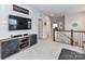Spacious loft area with a TV, modern cabinet, carpet and staircase overlooking the first floor at 5811 Mantle Way, Kannapolis, NC 28081
