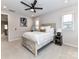 Comfortable bedroom with rustic wood bedframe, nightstand, carpet, ceiling fan and large windows at 5811 Mantle Way, Kannapolis, NC 28081