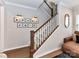 Stairway with wooden handrail and white risers, complemented by framed wall art and stylish lighting at 5811 Mantle Way, Kannapolis, NC 28081