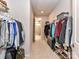Spacious walk-in closet with shelving for shoes and clothing and leads to the primary bathroom at 5811 Mantle Way, Kannapolis, NC 28081