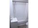 This bathroom has a shower and tub combination, a white shower curtain, and a white sink at 606 E 4Th Ave, Gastonia, NC 28054