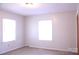 Bright bedroom with two windows and neutral walls and floors at 606 E 4Th Ave, Gastonia, NC 28054